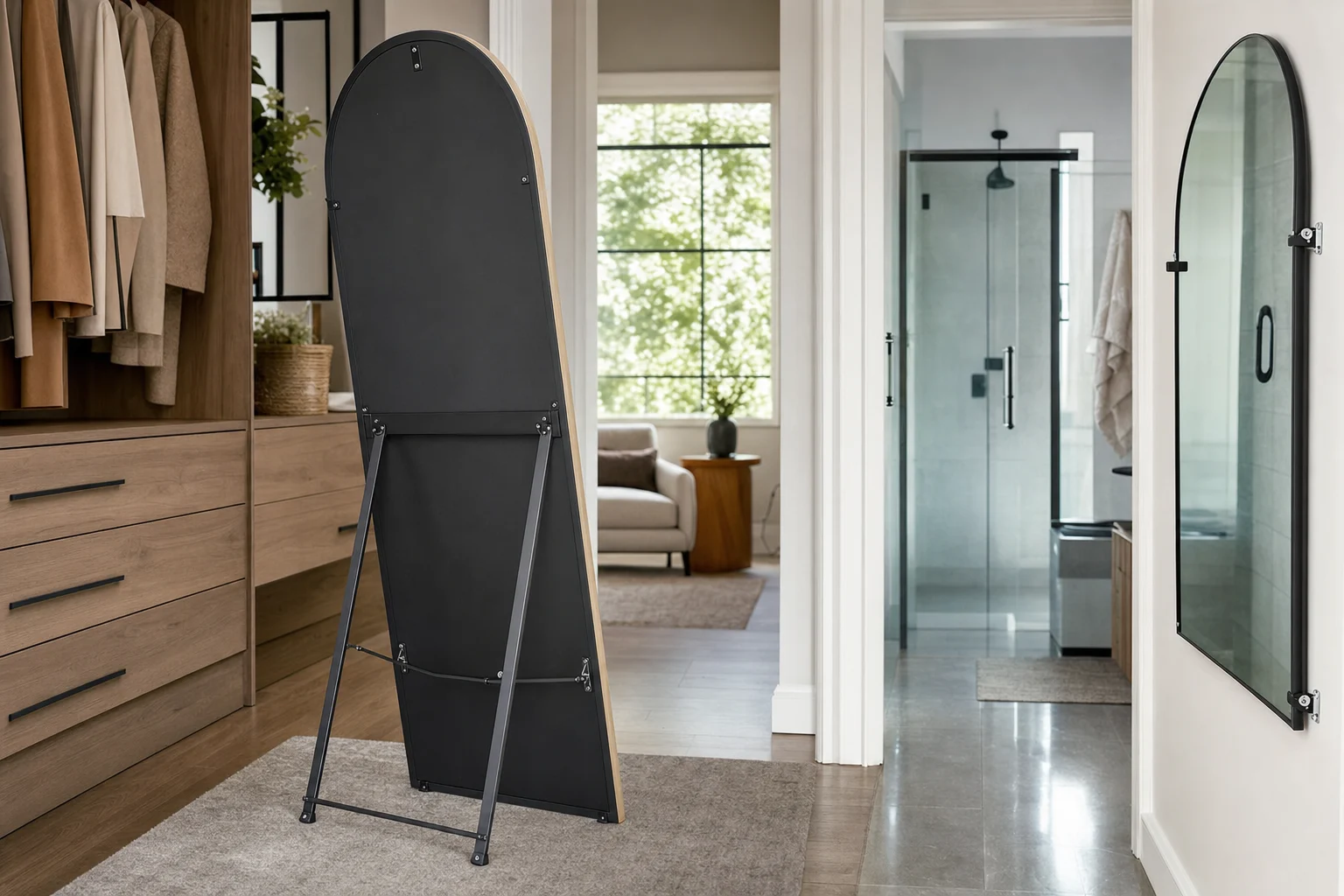 A realistic workshop-to-home style scene illustrating when to choose a freestanding arched mirror and when not to place it on the floor. In the foreground, a sturdy full-length arched mirror with rear support stand is placed safely in a spacious dry dressing area with flat flooring, showing thick backing, metal hinge support, and protective foot pads. In the background or adjacent area, another arched mirror is shown unsuitable for floor placement near a narrow walkway or humid bathroom-like zone, instead prepared for wall mounting with brackets and spacers visible. Focus on real mirror construction details: safety backing, frame thickness, curved arch top, polished edge or slim frame, installation hardware, floor condition, and room clearance. Soft natural light, practical home environment, slightly angled camera view, realistic product and installation photography, no text, no logo, no identifiable person.